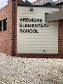Ardmore Elementary School dimensional letters mounted to a cream cladding panel beside the brick entry.