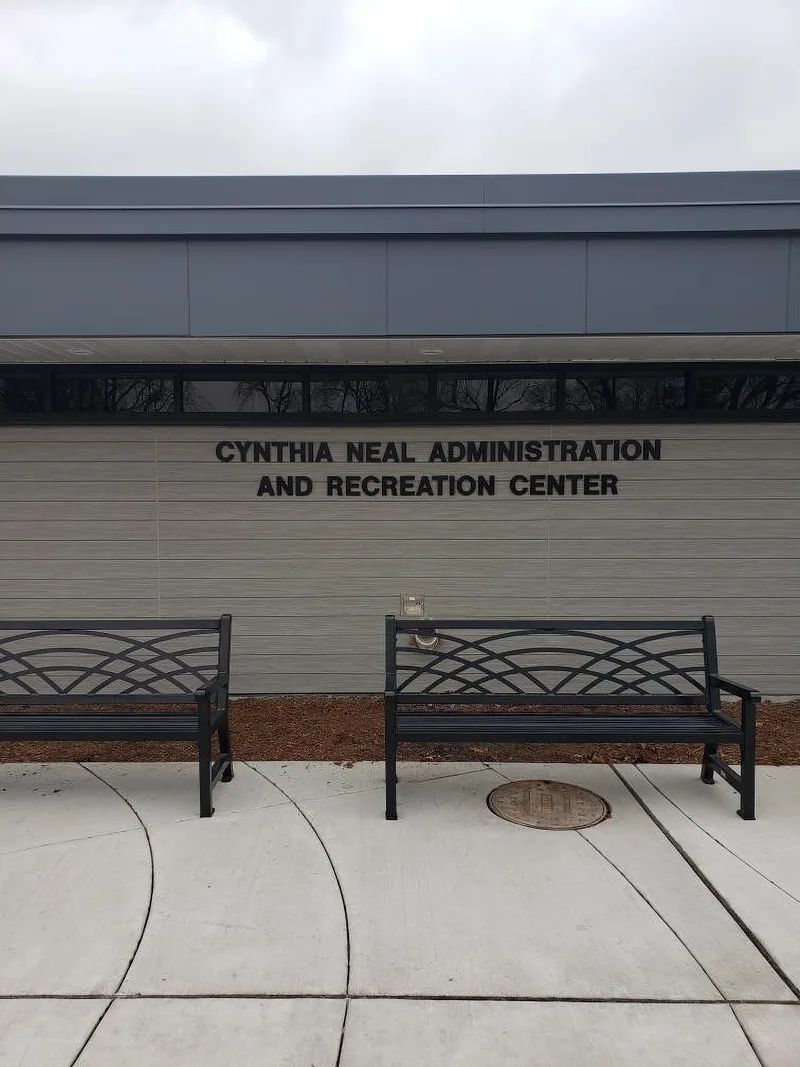 Cynthia Neal Administration and Recreation Center exterior building ID — slim dimensional letters across a tan paneled facade above a clerestory window.