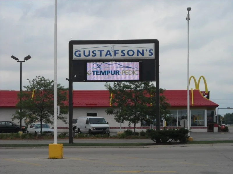 Gustafson's retail pylon sign with a full-color LED message center displaying a Tempur-Pedic promotion.