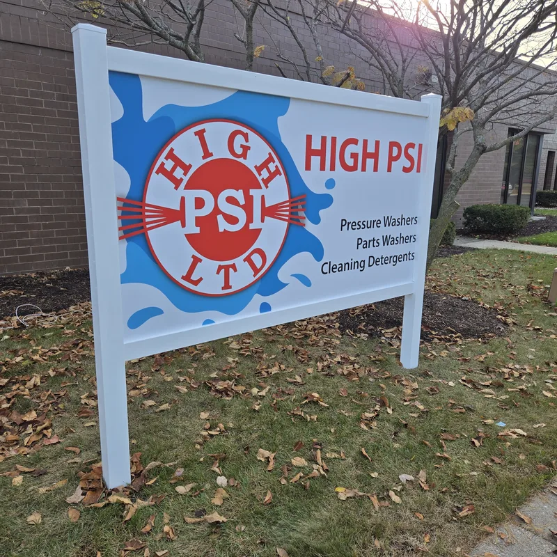 High PSI Ltd. post-and-panel sign — white frame with a splash-style "HIGH PSI" logo panel listing pressure washers, parts washers and cleaning detergents.