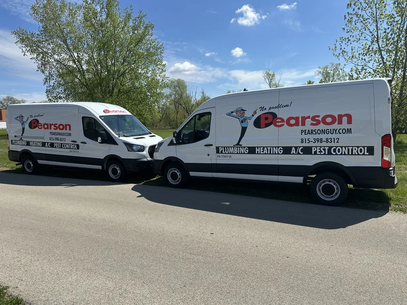 Two matching Pearson service vans with the "No problem!" mascot and red logo, showing consistent fleet branding across vehicles.