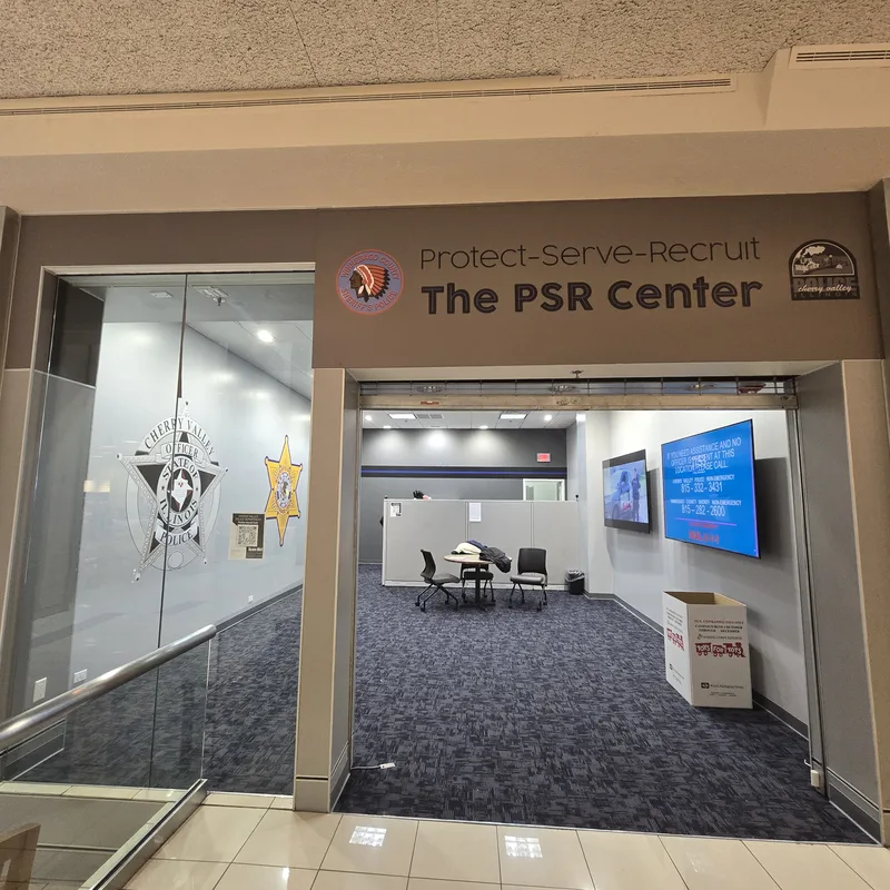 "Protect-Serve-Recruit — The PSR Center" fascia sign and badge window graphics at the Winnebago County Sheriff's recruiting storefront in CherryVale Mall.