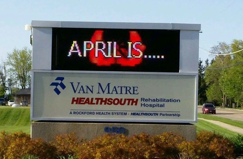 Van Matre HealthSouth Rehabilitation Hospital monument — full-color LED message center above an illuminated tenant cabinet with the Van Matre and HealthSouth logos.