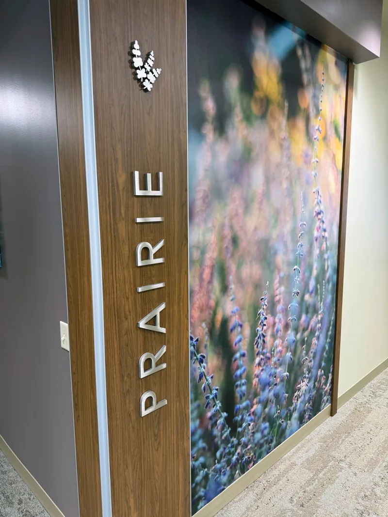 Conference room wayfinding sign with dimensional letters and printed wall graphic.